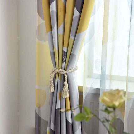 Mørklægningsgardin med abstrakt gul-grå mønster
