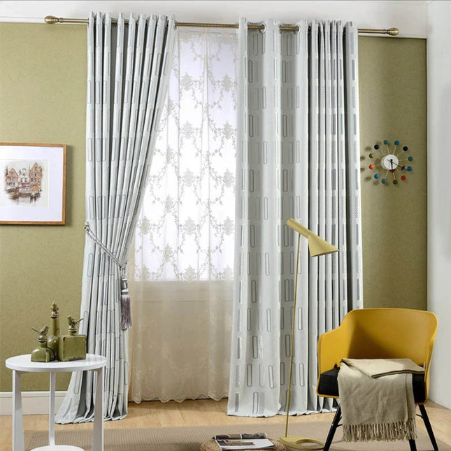 Gråt mørklægningsgardin med grafisk mønster